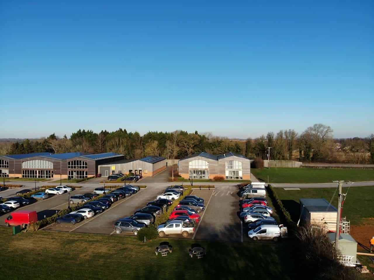Car park at Grovelands Business Park with office buildings behind
